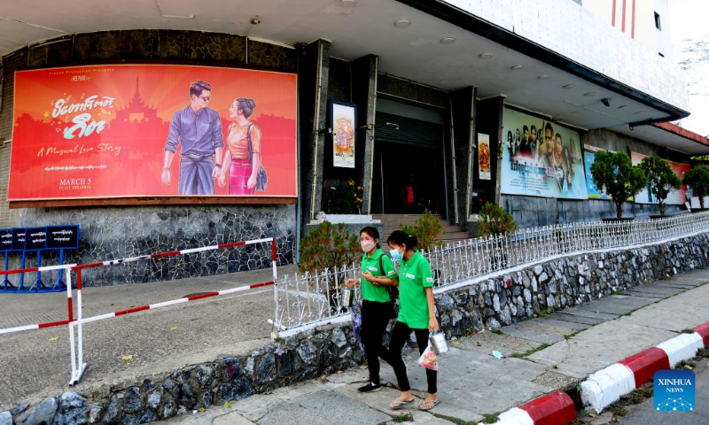 People walk past the shuttered Thamada Cinema in downtown Yangon, Myanmar, on March 24, 2022. Myanmar's Ministry of Information has announced to reopen about 60 movie theaters in the country starting on April 17, in accordance with Health Ministry's COVID-19 prevention and control measures. (Xinhua/U Aung)